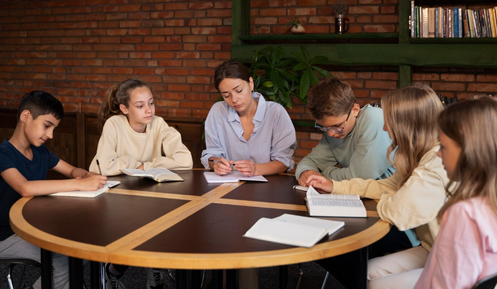 teacher using small-group instruction to support struggling students in class