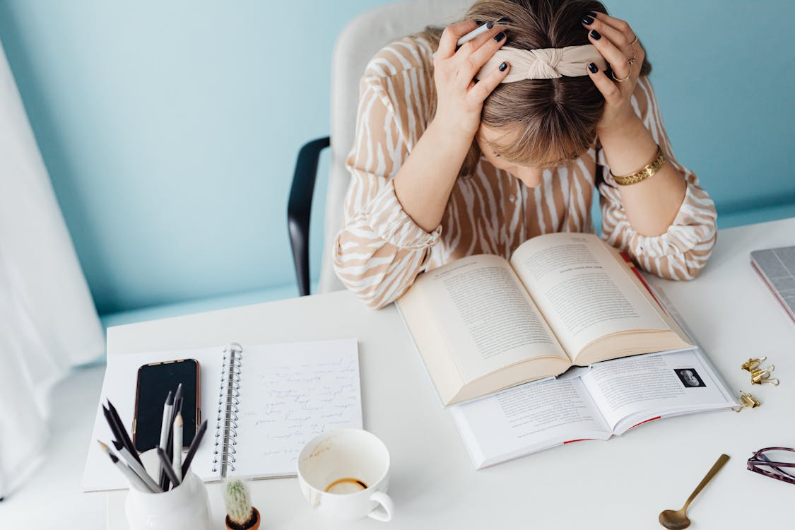 student showing how stress and anxiety affect learning while studying at a desk