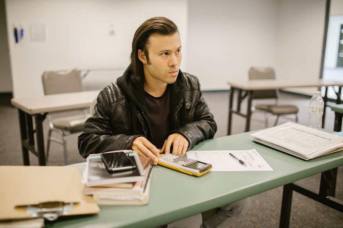 student using how to pass tough classes strategies while working through assignments