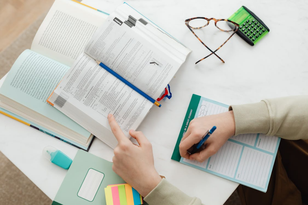 student using a planner and notes to build a study system at a desk